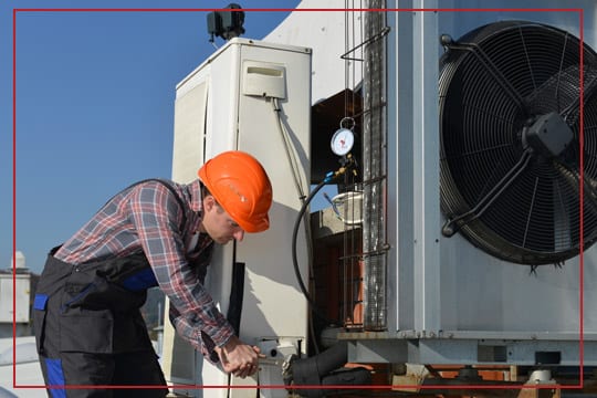 J.M. Taylor technician servicing an HVAC unit
